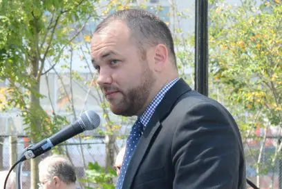 Corey Johnson at a microphone