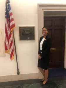 A young person stands in front of Representative Debbie Wasserman Schultz's Office