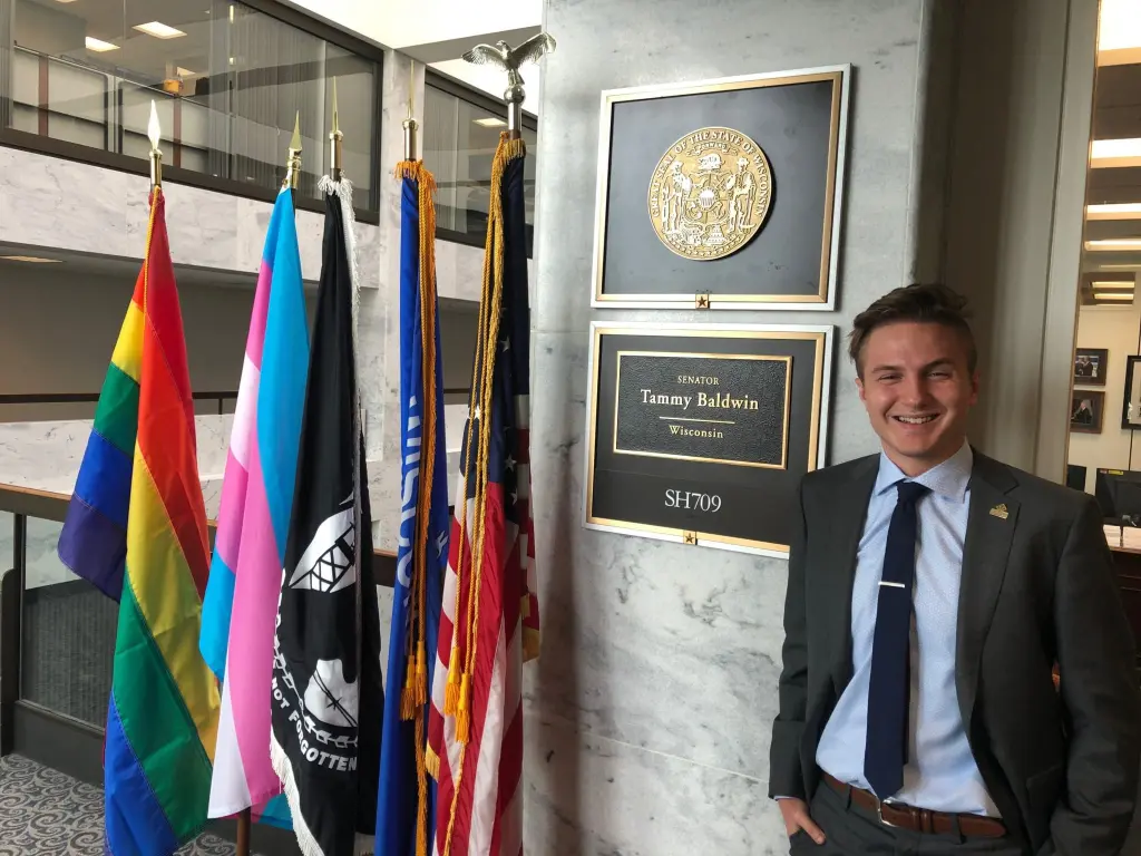 Victory Congressional Intern Brett Ries stands in front of Senator Tammy Baldwin's Office
