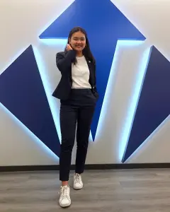 Victory Congressional Intern Marissa Wu stands in front of the Victory entrance V.