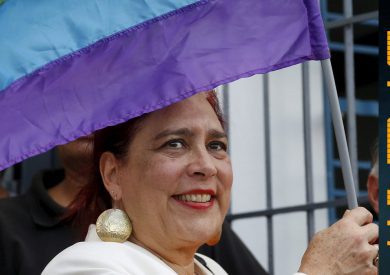 Venezuelan National Assembly Member Tamara Adrian holding a Pride Flag