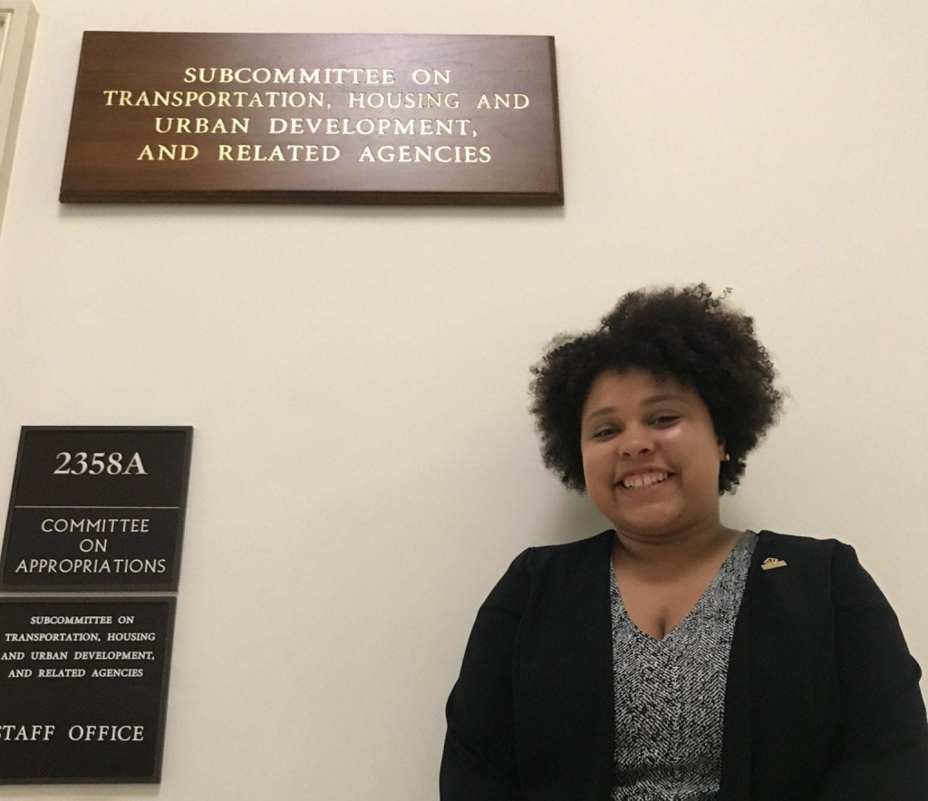 A young woman stands outside the office for the Subcommittee on Transportation, Housing, And Urban Development, And Related Agencies