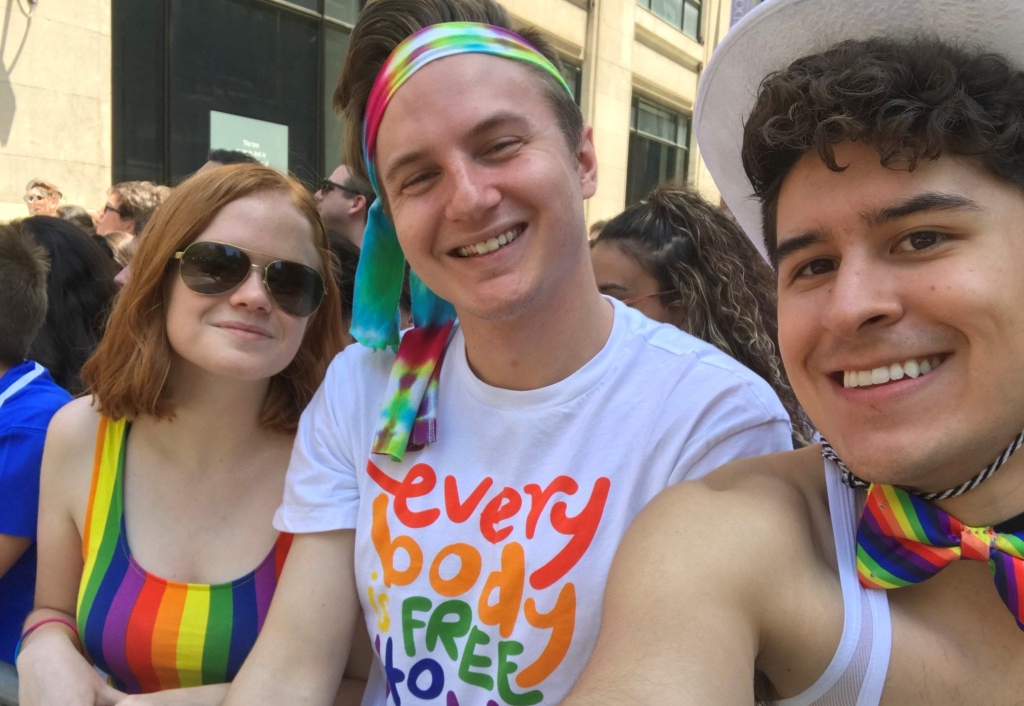 Three young people pose at NYC pride