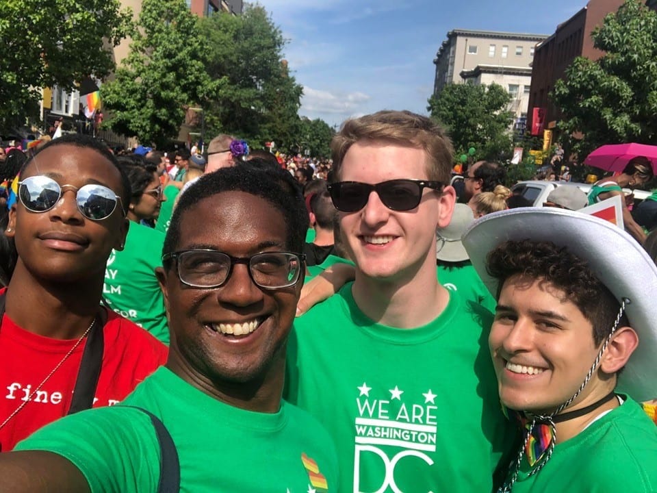 A group of four people pose at Capital Pride