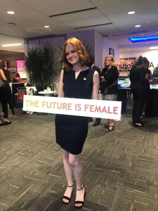 A Victory Congressional Intern holds a sign saying "The Future is Female"